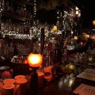 a bar with a lot of bottles and candles