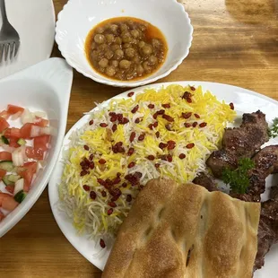 The #5 combo: 3 lamb kabobs-- partially hidden under the bread -- with rice, salad, and chickpea stew.