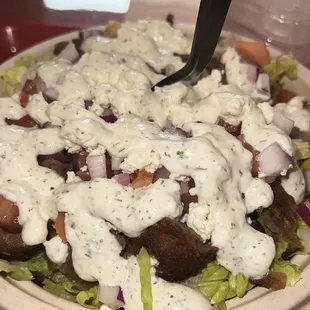 Gyros salad, with tzatziki sauce, and feta.
