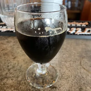 a glass of dark beer