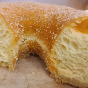 Cross section texture of a sugar yeast raised doughnut; soft, moist, spongy and doughie perfectly sweet.