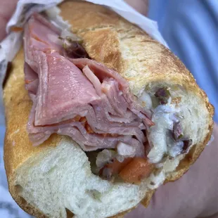 a person holding a sandwich
