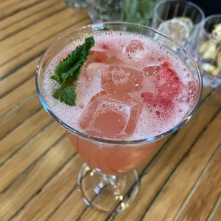 a pink drink with ice and mint