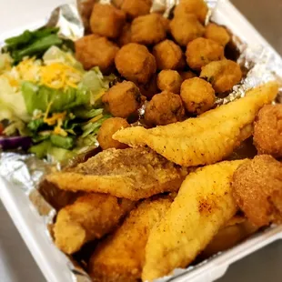 a tray of fried chicken and a salad