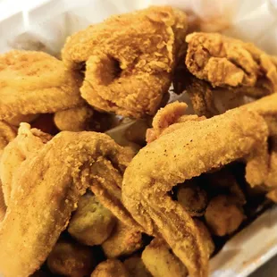 a close up of a basket of fried chicken