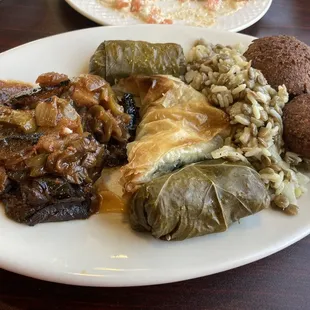 Vegetarian plate - with moussaka, spanakopita, grape leaves, mujaddara, and falafel.