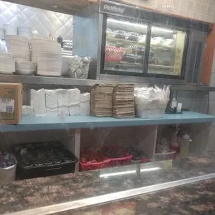 Open area with napkins and plates uncovered. Flies be all over this stuff and they still serve it. People put their cell phones on the napki