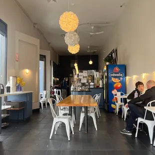 people sitting at tables in a coffee shop