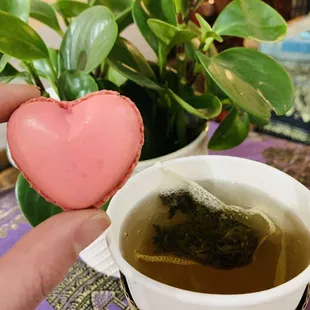 a cup of tea and a heart shaped cookie