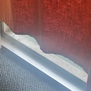 The dirt along the sliding door and the curtain that doesn't even reach the floor to keep the light out.