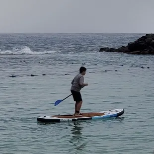 My son stand up paddle boarding