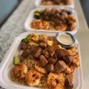 a row of trays of food