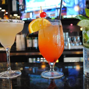 three cocktails on a bar