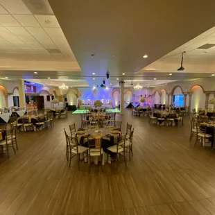 a banquet hall with tables and chairs