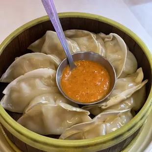 a bowl of soup and dumplings