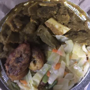 Curry goat with peas and rice and cabbage