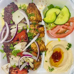 Combination Kabob with salad and hummus and rice .