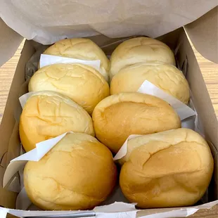 six rolls of bread in a box