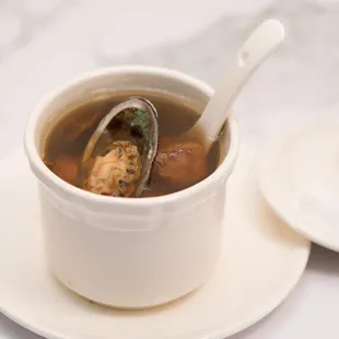 a cup of soup with a spoon in it