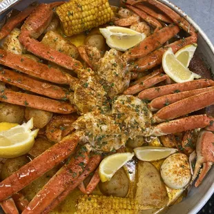 crab legs, potatoes, corn and lemons