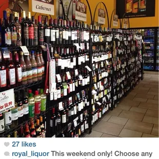 a wall of wine bottles in a store