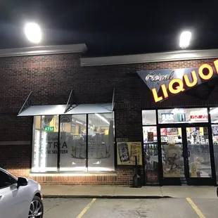 the front of a liquor store at night