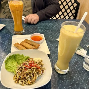 Two appetizers, Thai iced tea, and mango milkshake