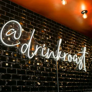 neon sign on brick wall