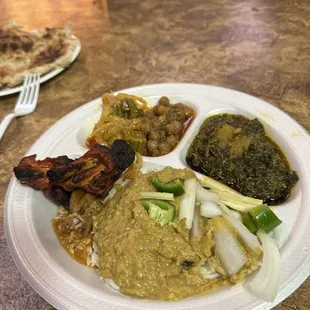 Buffet plate with haleem, saag, chickpeas, okra, and tandoori chicken