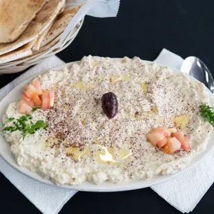 a plate of hummus and pita bread