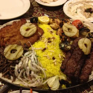 Chicken, lamb, beef, saffron rice, grilled onions, tomatoes, pineapple; very good!!!