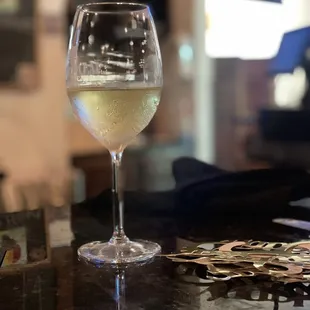a glass of wine on a bar