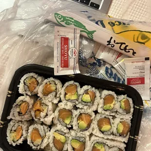 Two salmon avocado rolls and one spicy salmon roll