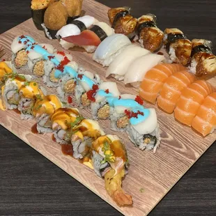 a variety of sushi on a wooden board