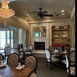 a formal dining room with a fireplace