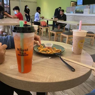 a person sitting at a table with a plate of food