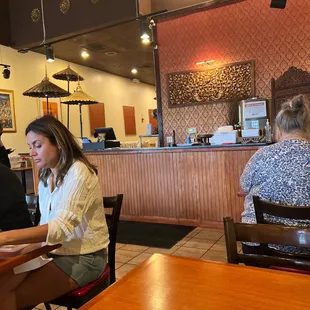 a woman sitting at a table in a restaurant