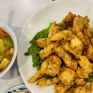 a plate of fried chicken and a bowl of soup