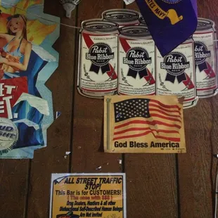 a variety of beer cans and signs