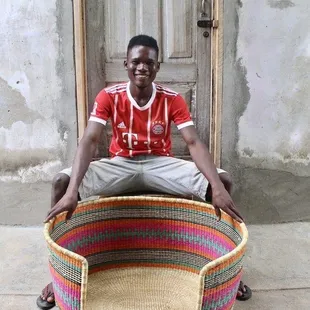a man sitting on a basket
