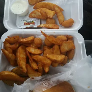 Pork sandwich on cornbread with potato wedges, fried pickles, and corn nuggets. Life is good