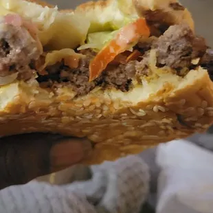 a hand holding a sandwich