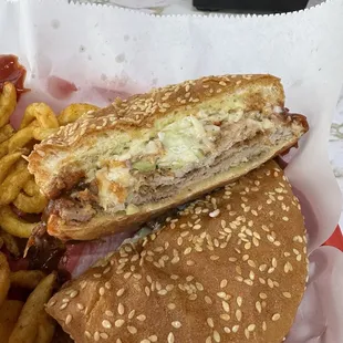 A BBQ Pork Sandwich, with coleslaw and curly fries.