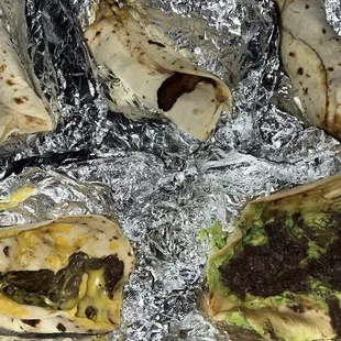 Top from left to right: bean and cheese w/ bacon x2, carne Guisada w/ cheese Bottom: beef fajita with cheese, Barbacoa with guacamole