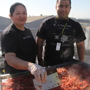 a man and a woman preparing food