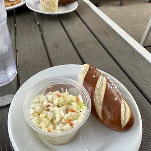 Cole slaw and pretzel roll comes with meal