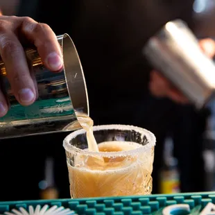 a bartender pouring a drink