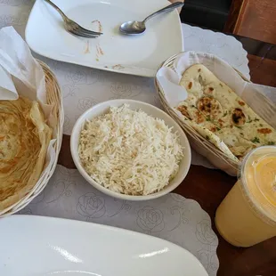 Paratha, rice, garlic naan, and a mango lassi