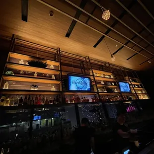 a view of a bar with a large screen tv
