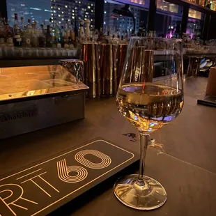 a glass of wine on a bar counter